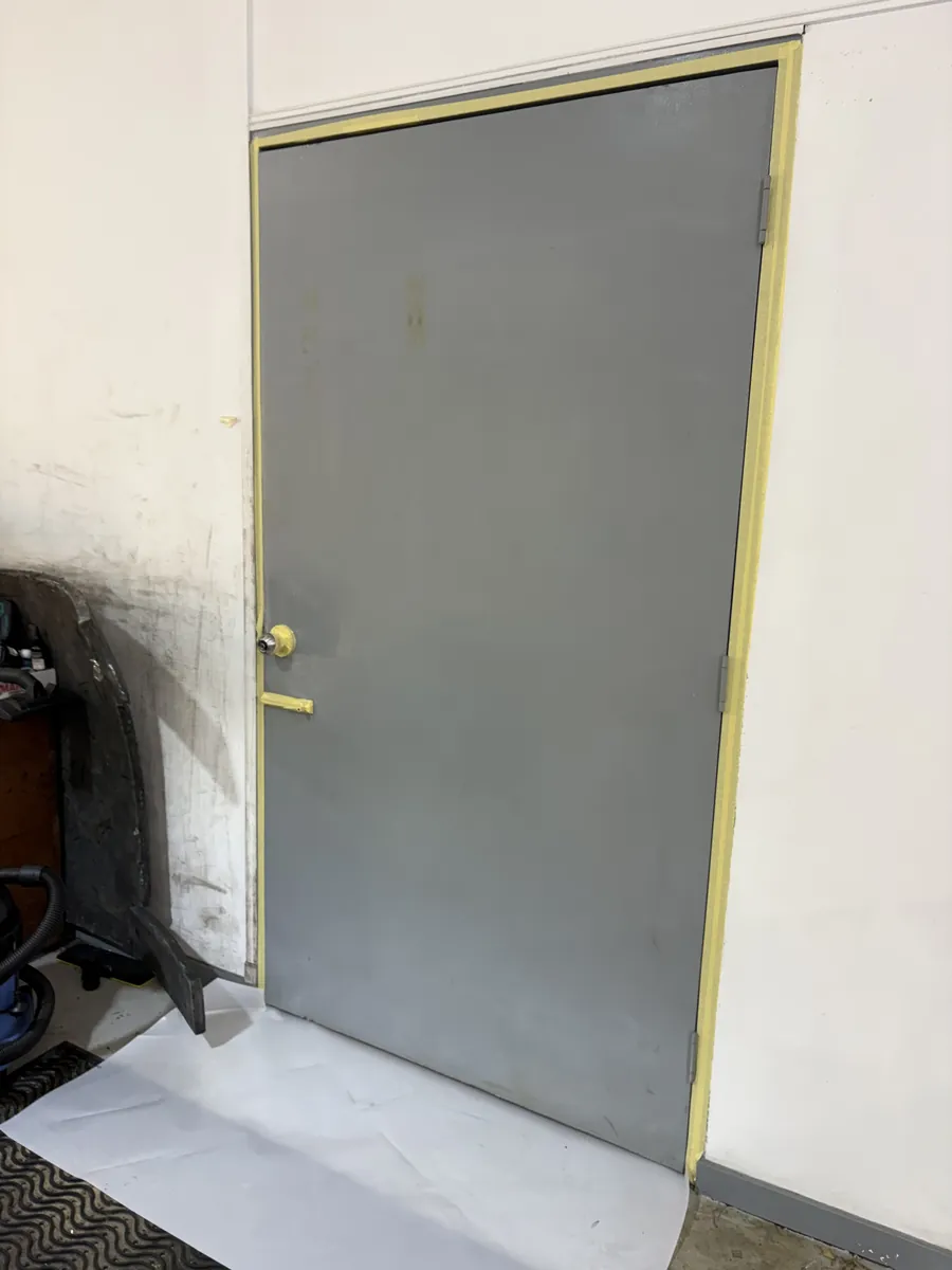 Grey door freshly rolled, drop sheet on the floor