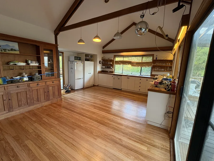 Cathedral ceiling and exposed timber beams above a living space