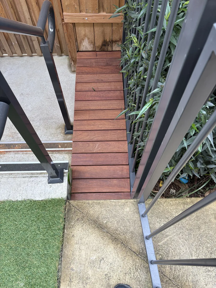 New timber steps and walkway beside a hedge